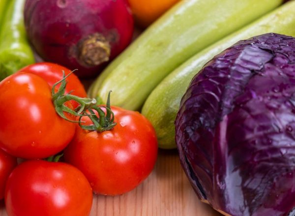 A vibrant assortment of fresh, organic vegetables on a wooden table, perfect for healthy eating.